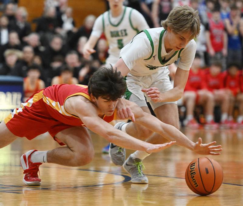 Batavia’s Kyle Porter, left, and York’s Brendan Molis chase a loose ball during the Addison Trail Class 4A boys basketball sectional semifinal on Wednesday, Feb. 28, 2024 in Addison.
