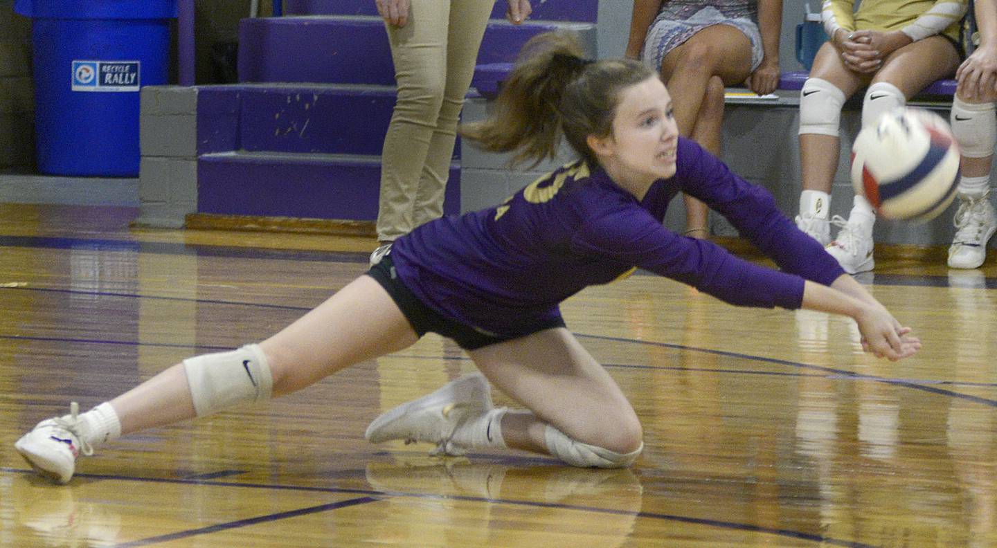 Hannah McNelis dives to return a volley from Woodland in the second set Tuesday at Serena.