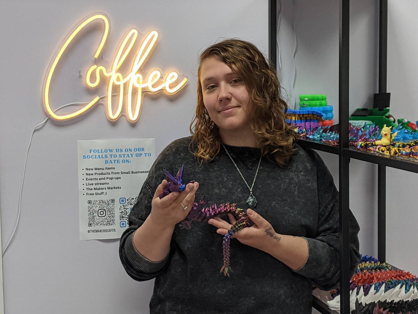 Hailey Stark, owner of StarkieProduction, holds up a crystal dragon 3D print that she made. The dragon is one of the items for sale at The Makers Cafe and Markets in Oswego.