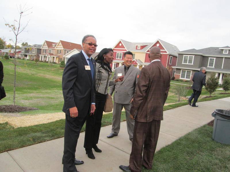 Housing Authority of Joliet CEO Michael Simelton tallks with Joliet Councilwoman Bettye Gavin (center) and John Chow, HAJ chief of development and operations (right) during a ribbon-cutting event at Water's Edge on Thursday.