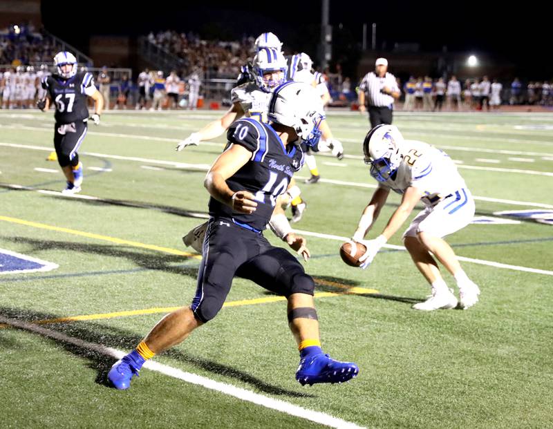 Wheaton North’s Nik Schaafsma (right) picks up a fumble from St. Charles North quarterback Ethan Plumb during a game Friday, Sept. 13, 2024 at St. Charles North.