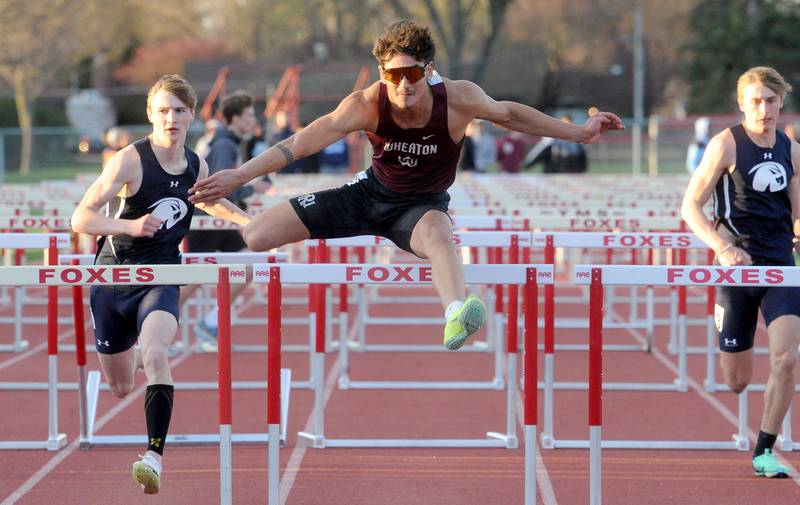 Wheaton Academy's Canyon Roberts pulls ahead of two Prairie Central hurdlers, during the Matt Wulf Track and Field Invitational at Yorkville High School on Friday, April 12, 2024.