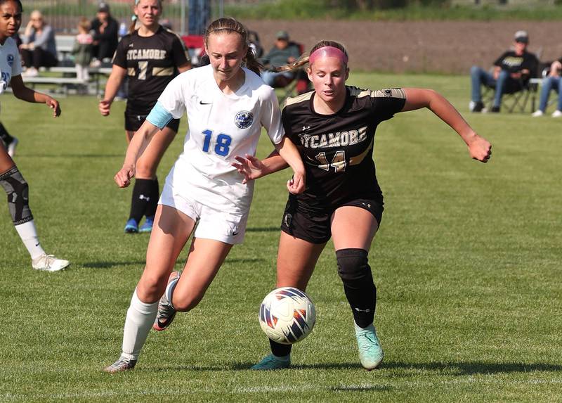 Woodstock's Lily Novelle and Sycamore's Peyton Wright fight for possession during their Class 2A regional semifinal game Wednesday, May 15, 2024, at Kaneland High School in Maple Park.