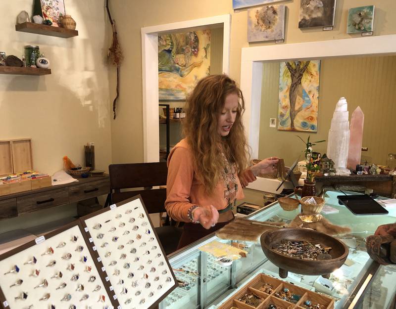 Steph Perez, one of the proprietors of Crystal Lume, talks to a customer at the store, 1310 Riverside Dr. Mchenry, on Thursday, Oct. 10, 2024. The metaphysical shop is celebrating one year in businesses from Oct. 17 to Oct. 20.