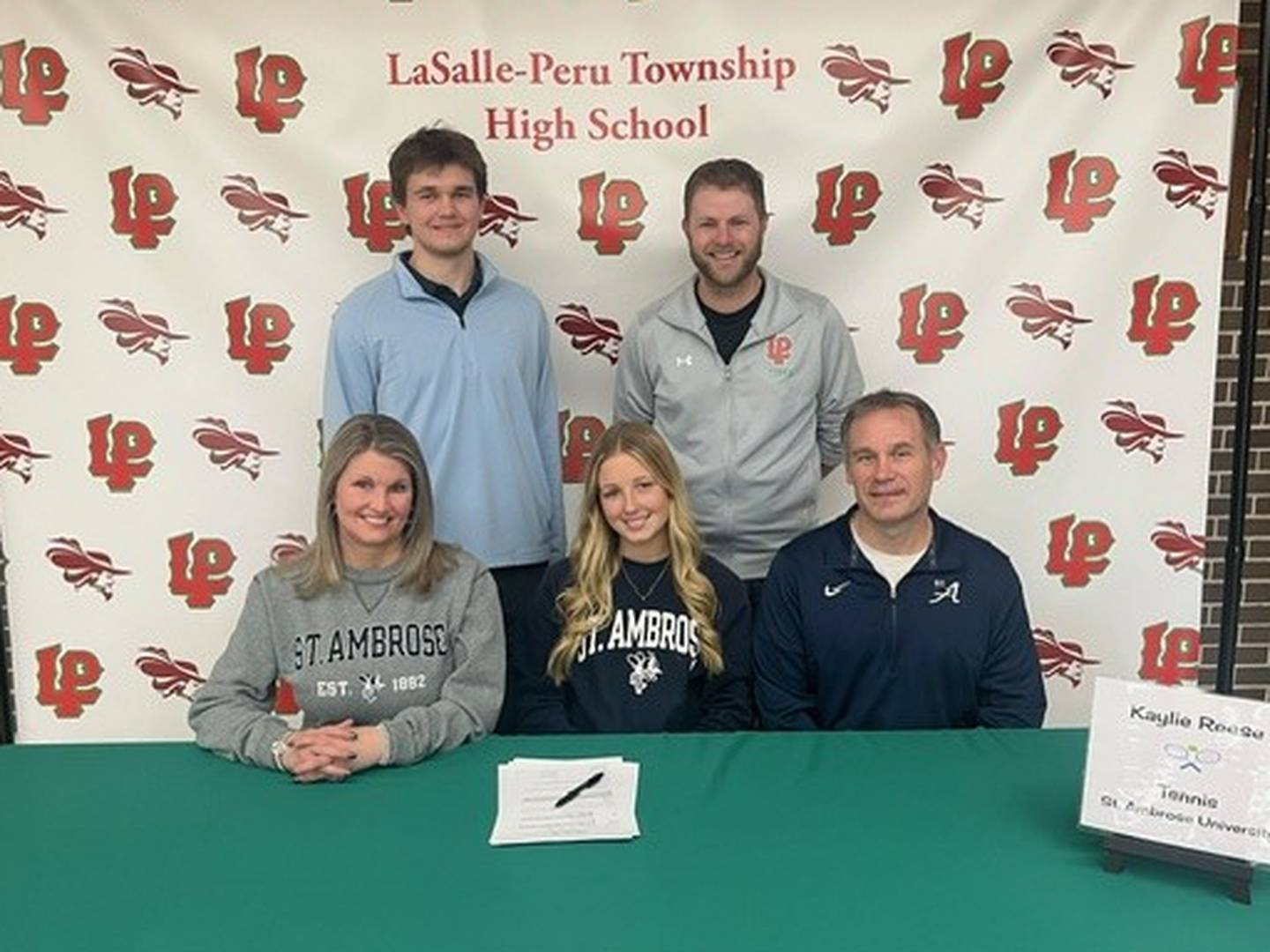 La Salle-Peru senior Kaylie Reese (seated, center) committed to play tennis at St. Ambrose University. She was joined by her parents (seated) Kim and Bob, her brother, Connor (standing, left) and L-P coach Aaron Guenther.