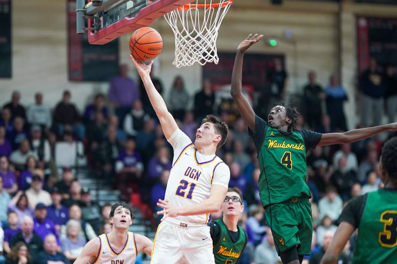 Downers Grove North's Jack Stanton (21) drives to the basket against Waubonsie Valley's Moses Wilson (4) during a Class 4A East Aurora sectional semifinal basketball game at East Aurora High School on Wednesday, Feb 28, 2024.