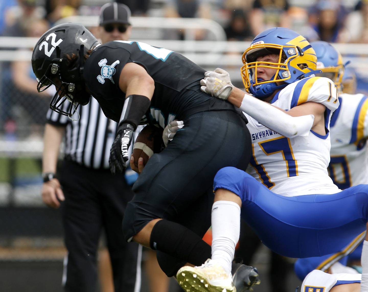 Johnsburg's Kaeden Frost tries to tackle Woodstock North's Parker Halihan during a Kishwaukee River Conference football game Saturday, Aug. 26, 2023, at Woodstock North High School.