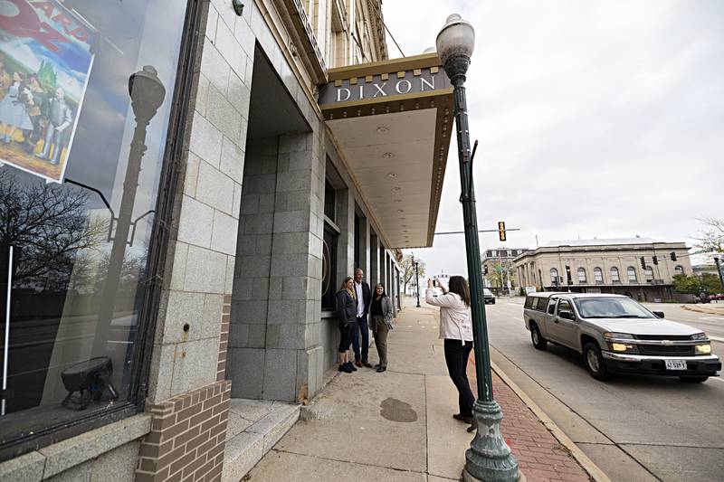 Sauk Valley Bank’s Jessica Bovee snaps a picture of Dixon Theatre’s Scott Shipp (left), Mike Venier and Jessica Dempsey Thursday, Oct. 19, 2023. The bank is working on a new home town campaign.