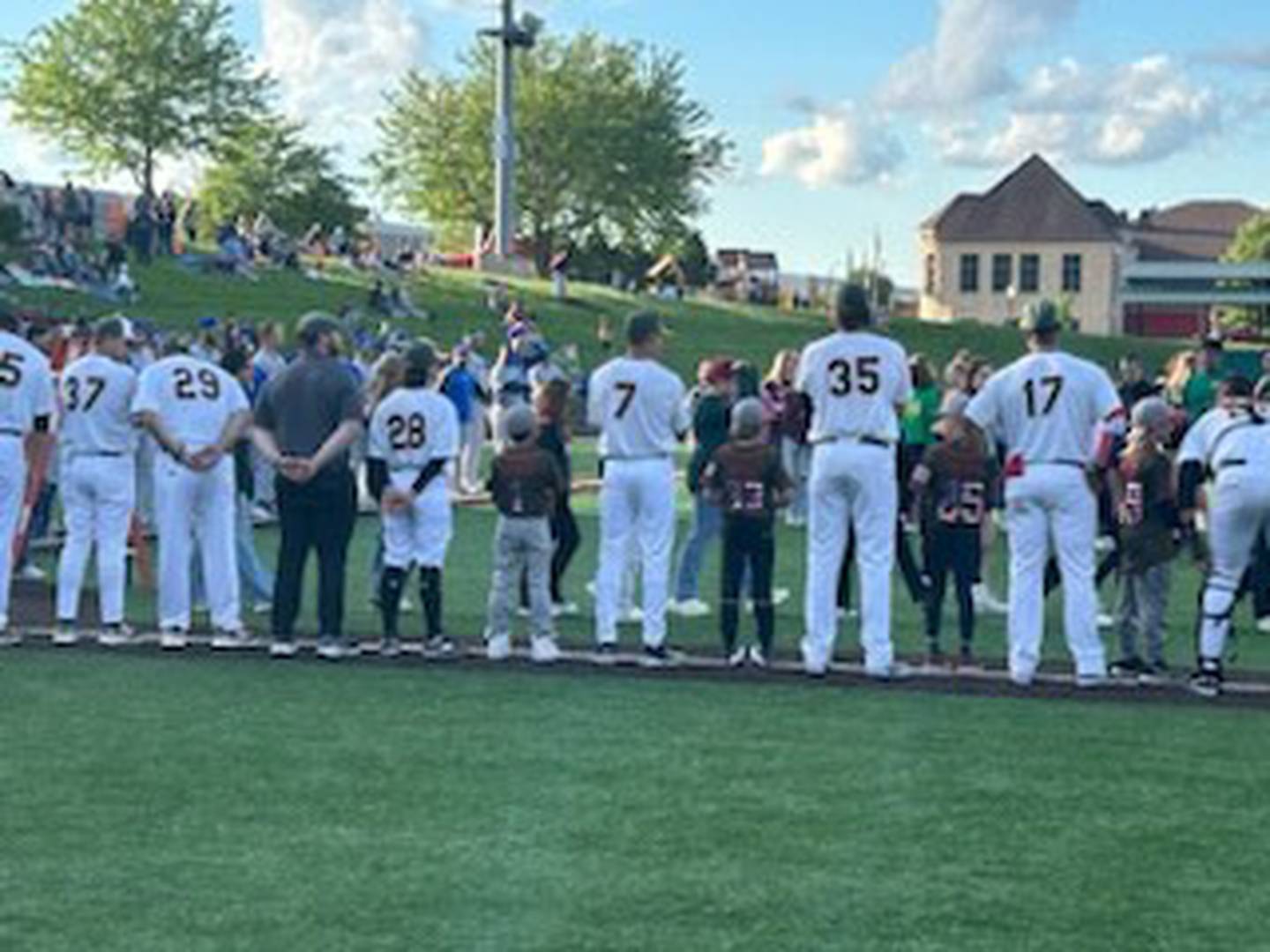Channahon Little League players join the Joliet Slammers on the field for the National Anthem on opening night May 10.