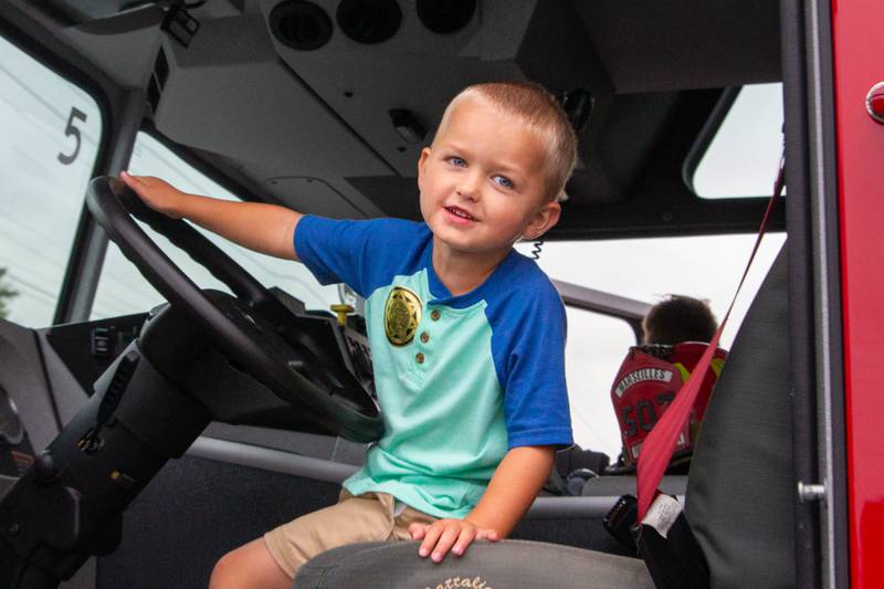 Lukas Wickersham poses for picture in the driver seat of a fire truck on Tuesday, August 6, 2024 at Marseilles Swimming Pool.