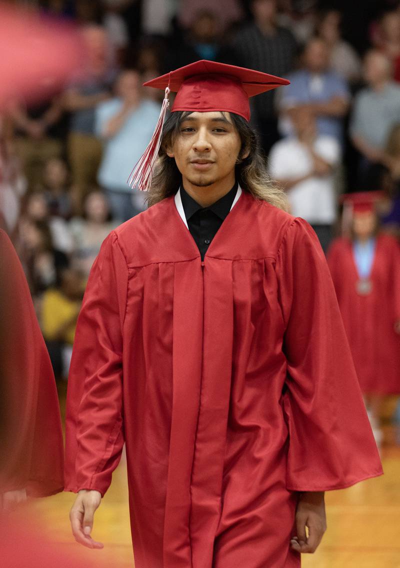 Cristian Flores walks down the center of the gym Sunday, May 19, 2024, during the graduation processional at Streator High School.