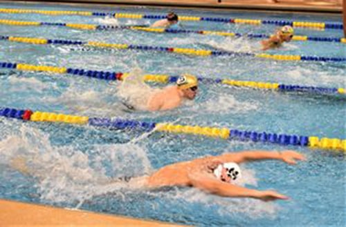 Sterling and Byron swimmers compete in the 100 butterfly race during a 2023 dual meet at the Duis Center.