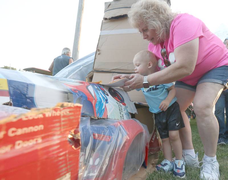 Hudson Wiede of Peru, and his grandmother Suzette, check out a Spiderman door prize during the Cops 4 Cancer fundraiser on Friday, July 26, 2024 at Cerri Memorial Park in Cedar Point. Cops 4 Cancer began in 2003. The group helps families in their fight against cancer, by providing financial assistance in a variety of ways.