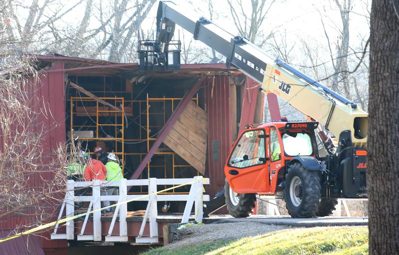 An Illinois Department of Transportation crew begins repairs on the Red Covered Bridge on Monday, Dec. 11, 2023 in Princeton. The bridge was severely damaged when it was struck by a semi truck on Nov. 16.