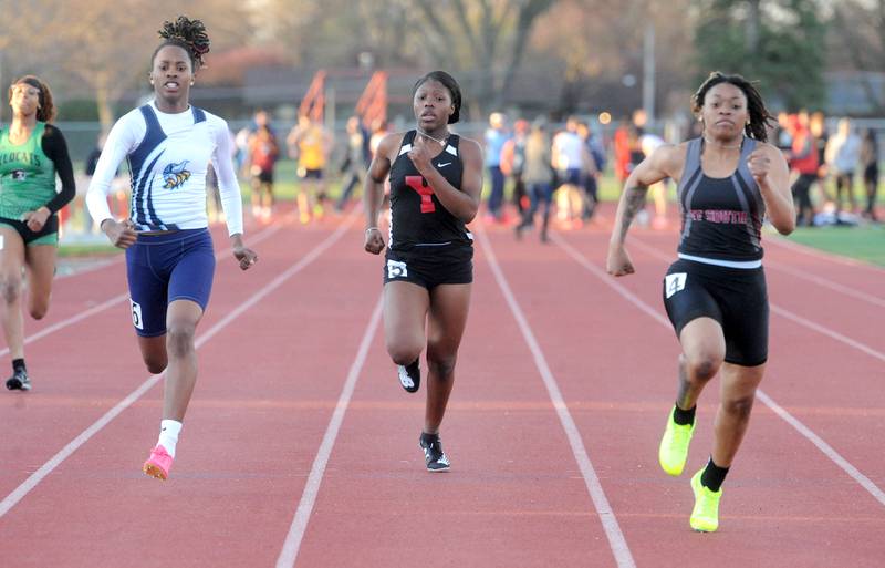 Thorton Fractional's Janiya Lucan (right), Yorkville's D'Vine Wright and Rockford Guilford's Zariah Burnett battle to the finish of the 100 Meter Dash during the Matt Wulf Track and Field Invitational at Yorkville High School on Friday, April 12, 2024.