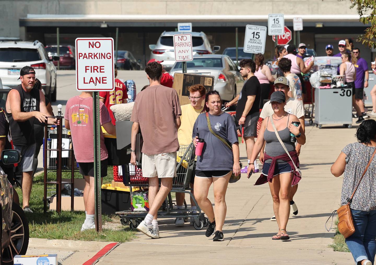 Northern Illinois University student volunteers help new arrivals get their things moved into their rooms Wednesday, Aug. 23, 2023, during move-in day in front of the Fanny Ruth Patterson Complex at NIU in DeKalb.