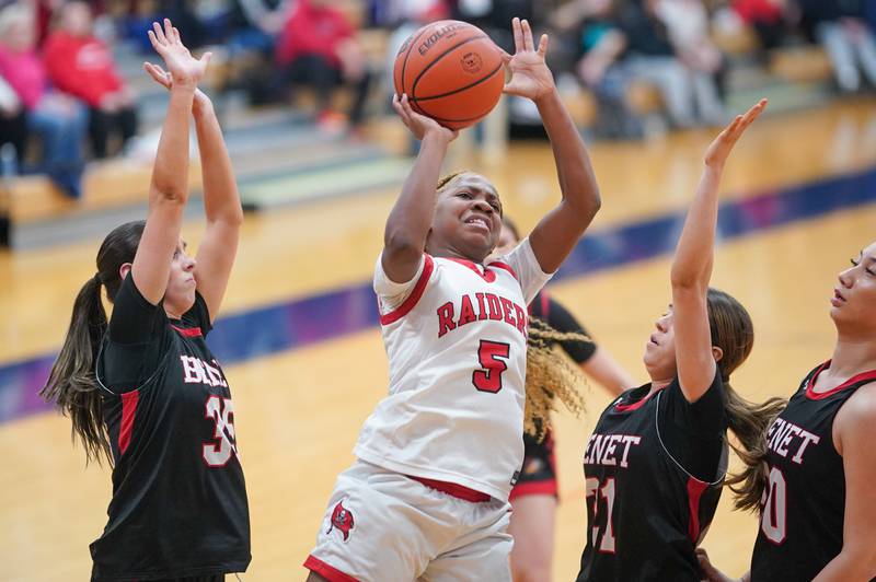 Bolingbrook's Ciyah Thomas (5) shoots the ball in the paint against Benet’s Emilia Sularski (35) and Kiera Moran (31) during a Oswego semifinal sectional 4A basketball game at Oswego High School on Tuesday, Feb 20, 2024.