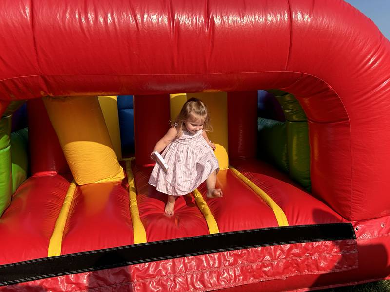 Sophia Palumbo, 2, of Prophetstown exits the inflatable obstacle course for kids at Prophetstown's Fourth Friday on Friday, July 26, 2024. Farmer's National Bank. one of the businesses that took part in the event, sponsored the inflatable.