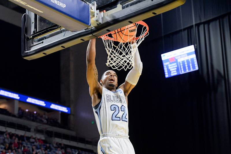 Elmhurst University's Wesley Hooker, a Downers Grove South graduate, dunks the ball during the team's Final Four win over Wabash.