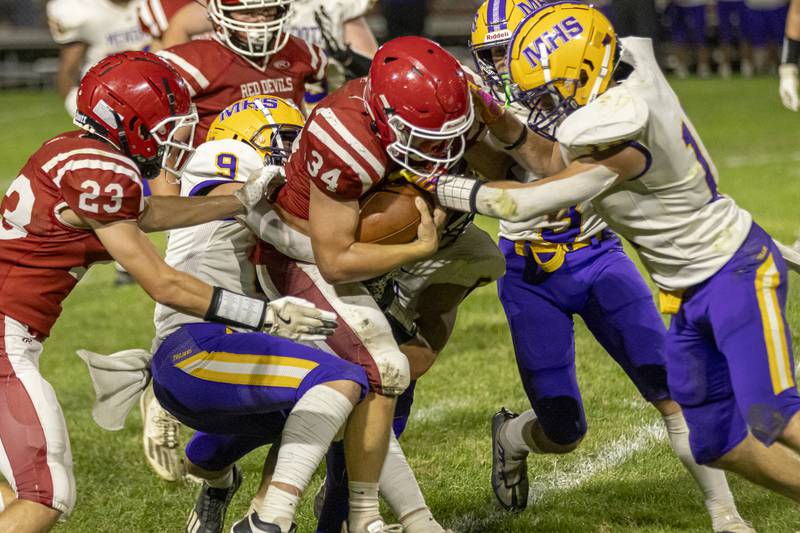 Jack Curran of Hall High School gains yardage while being triple teamed by Mendota's defense during the game at Richard Nesti Stadium on September 13, 2024.