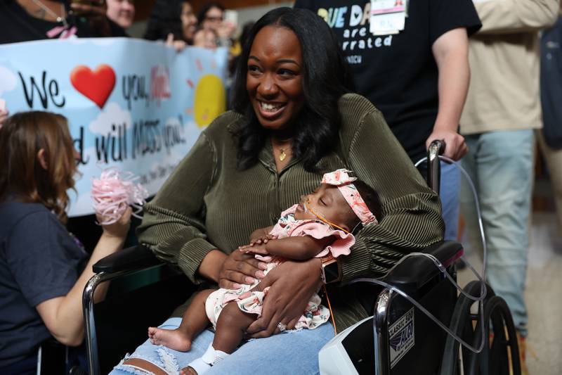 Nakeya Haywood holds her daughter Nyla as they leave the hospital during a send off party at Silver Cross Hospital on Monday, May 13, 2024 in New Lenox. Nyla is the youngest preemie, born Nov. 17, 2023, at 22 weeks and 3 days, weighing 1.1 pounds, Silver Cross Hospital’s NICU has cared for.