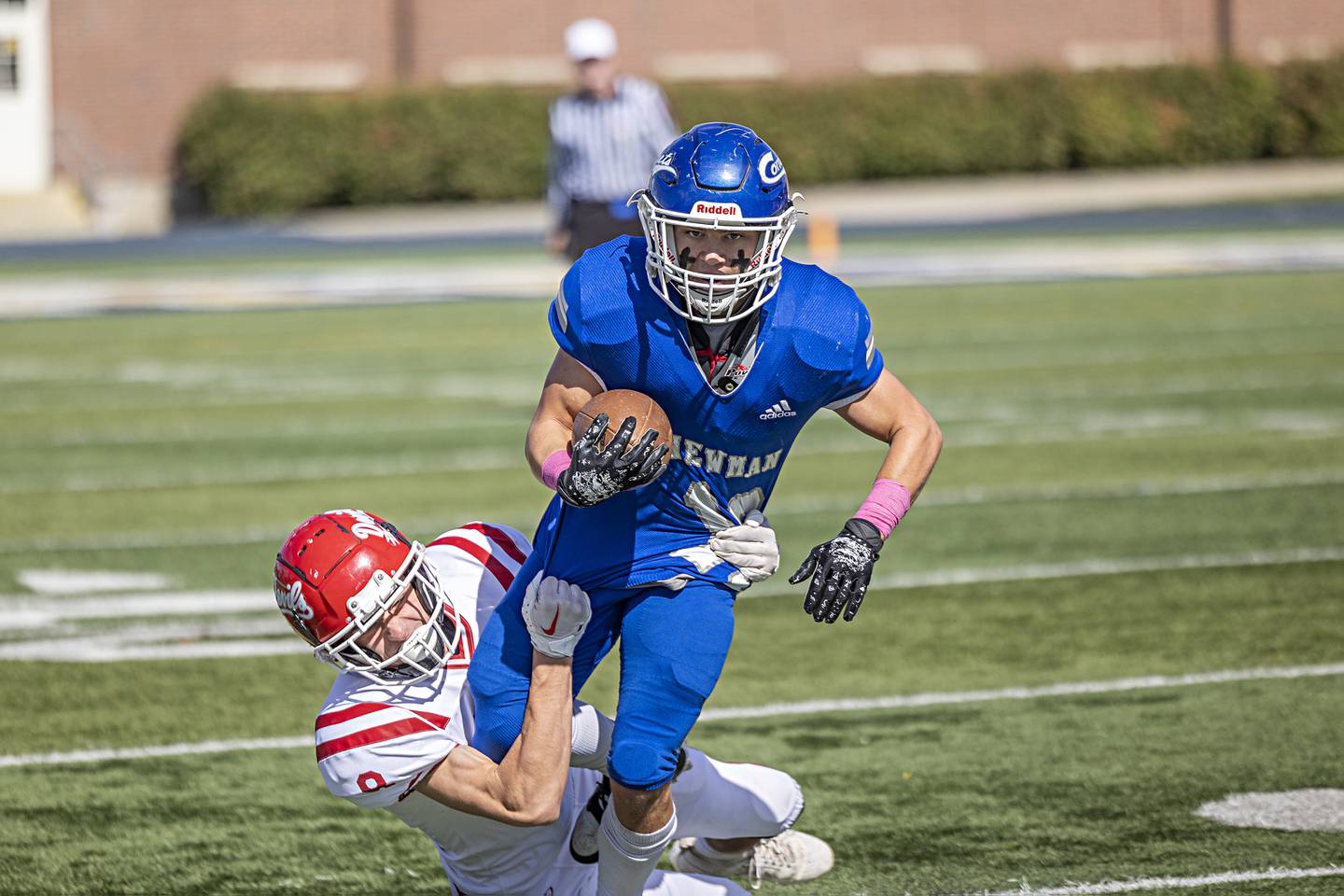 Newman’s Brady Grennan is hauled down by Hall’s Braden Curran Saturday, Oct. 7, 2023 in Sterling.