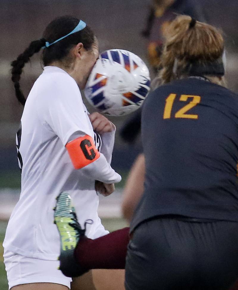 McHenry’s Mara Torres takes a ball to the face that was kicked by Richmond-Burton’s Madison Havlicek during a non-conference girls soccer match Thursday, March 16, 2023, at Richmond-Burton High.