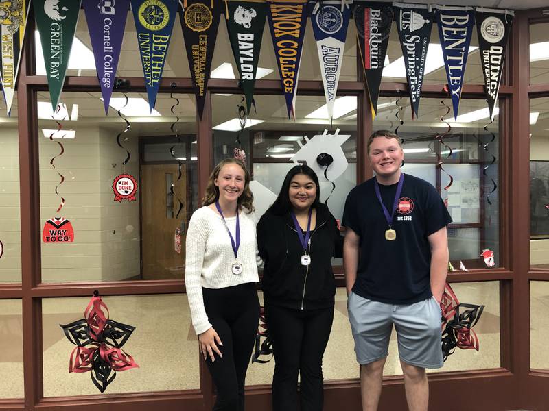 Huntley High School dual degree graduates Addison Raistrick, Amanda Sarrol and Kyle Kane pose for a photo at Huntley High School May 9, 2024.