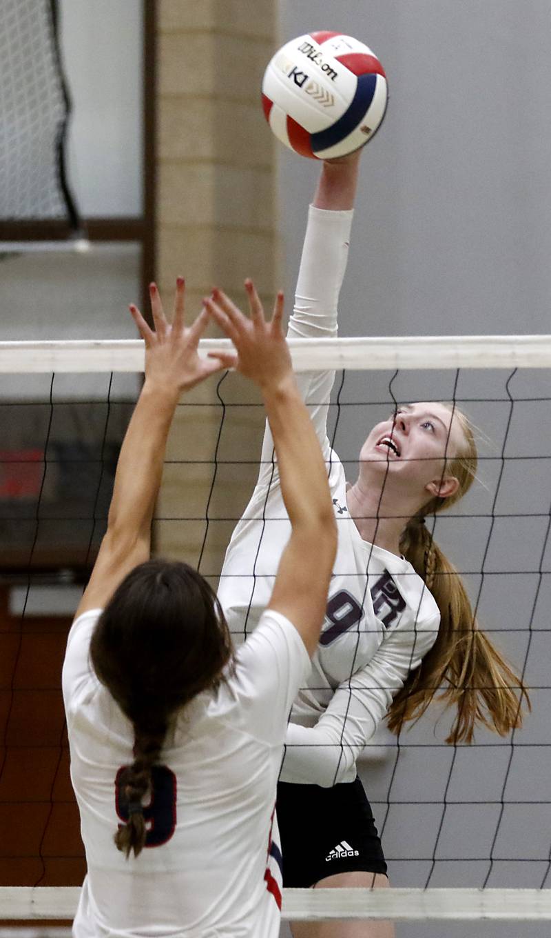 Prairie Ridge's Ashley Stiefer hits the ball over Belvidere North's Mya Potter during the Class 3A Woodstock North Sectional finals volleyball match on Wednesday, Nov. 1, 2023, at Woodstock North High School.