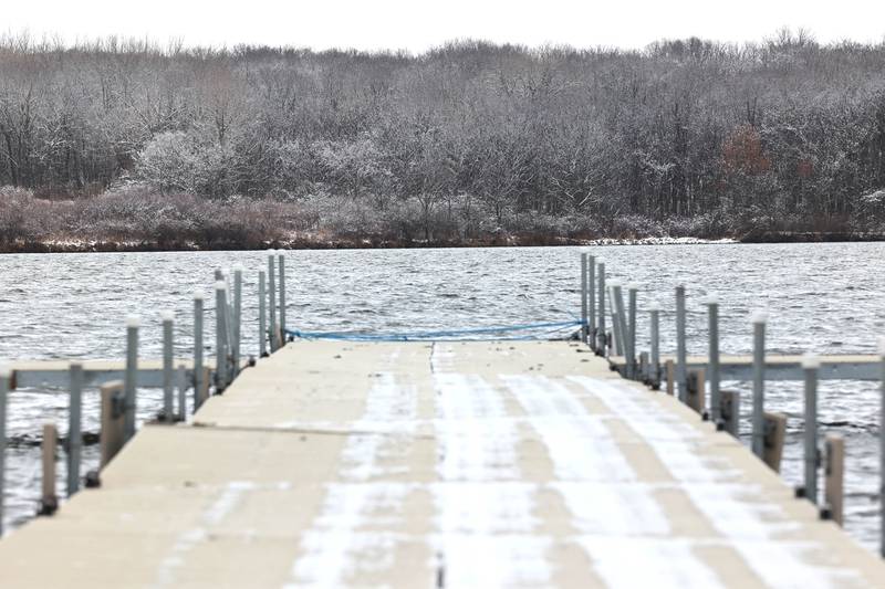 A snowy dock leads into Shabbona Lake Friday, March 10, 2023, at Shabbona Lake State Park in Shabbona. Snow over night in DeKalb County resulted in a dusting to four inches depending on where you were at.