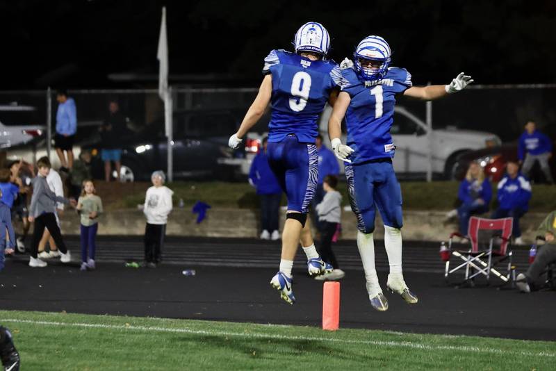 Arthur Burden (9) and Casey Etheridge (1) celebrate a Tigers touchdown in Friday's 57-20 win over Mercer County at Bryant Field.