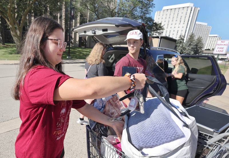 Northern Illinois University sophomore Gabby Gozdecki, (left) from Palatine, gets some help from volunteers from the Phi Sigma Kappa fraternity unloading her van Thursday, Aug. 18, 2022, as she moves into New Residence Hall at NIU. Thursday was one of four move-in days for students attending the upcoming school year.