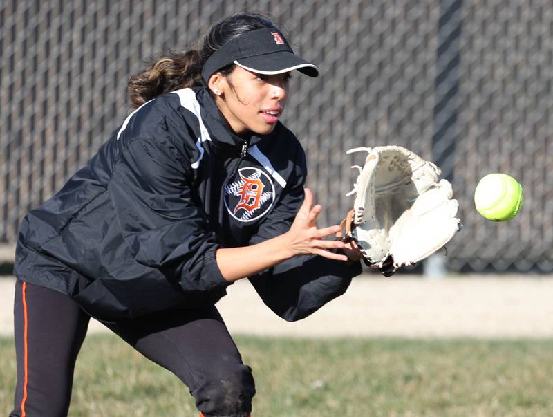 DeKalb's Nazeria Dean plays a ball on a hop in left field during their game against Sandwich Tuesday, March 19, 2024, at DeKalb High School.