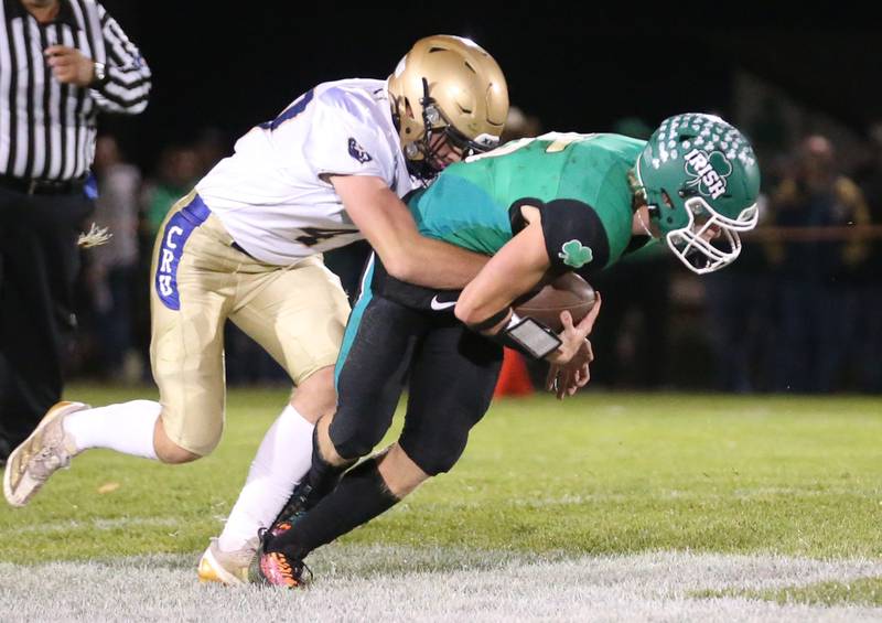 Marquette's Keaton Davis brings down Seneca quarterback Paxton Giertz on Friday, Oct. 18, 2024 at Seneca High School.