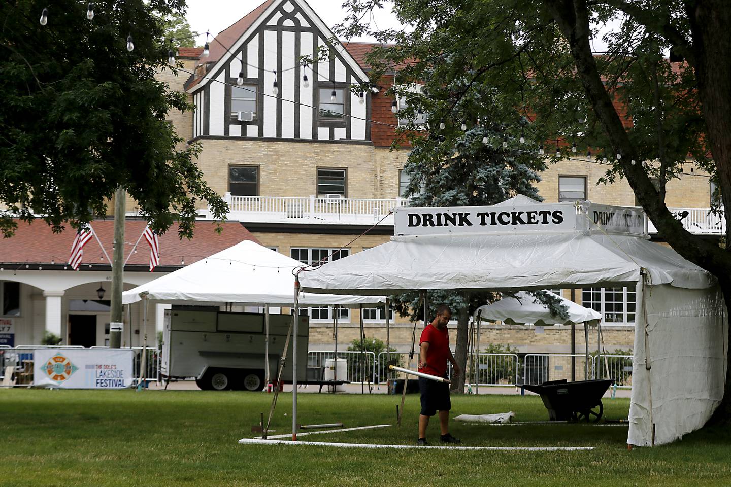 A worker sets up a tend in from of the Dole Tuesday, July 2, 2024, for the Lakeside Festival at the Dole. The festival runs from July 4, through July 7.