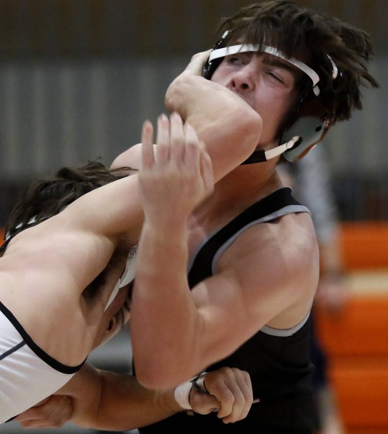 Prairie Ridge’s Milkey Meade fends of a hand to the faces as he battles Kaneland’s Alex Gochis during the 126-pound championship match of a the IHSA 2A Crystal Lake Central Wrestling Regional on Saturday, Feb. 3, 2024, at Crystal Lake Central High School.