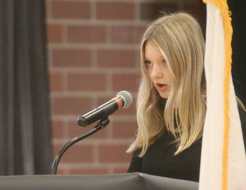 Student Caroline Ambel reads her poem called "Valor Unending" during the Parkside School Veterans Day Program on Friday, Nov. 10, 2023 at Parkside Middle School in Peru.