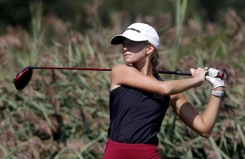 Prairie Ridge’s Jenna Albanese watches her tee shot on the 9th hole of the Prairie course during the McHenry County Tournament on Thursday, Sept.12, 2024, at Boone Creek Golf Club in Bull Valley.