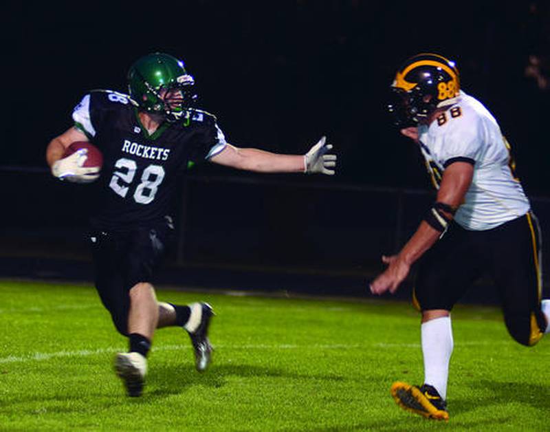 Rock Falls' Brendon LeBarron looks to break a tackle Friday against Harvard at Hinders Field. Harvard won 47-16.