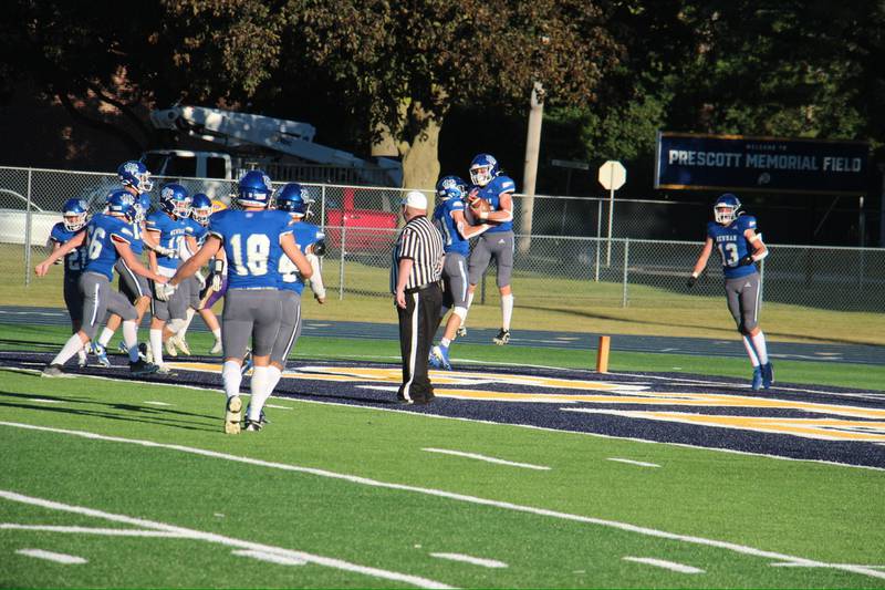 Newman's Daniel Kelly, pictured with the ball, celebrates his touchdown with Cody McBride on Saturday, Sept. 7, 2024. The Comets beat Mendota 42-0.