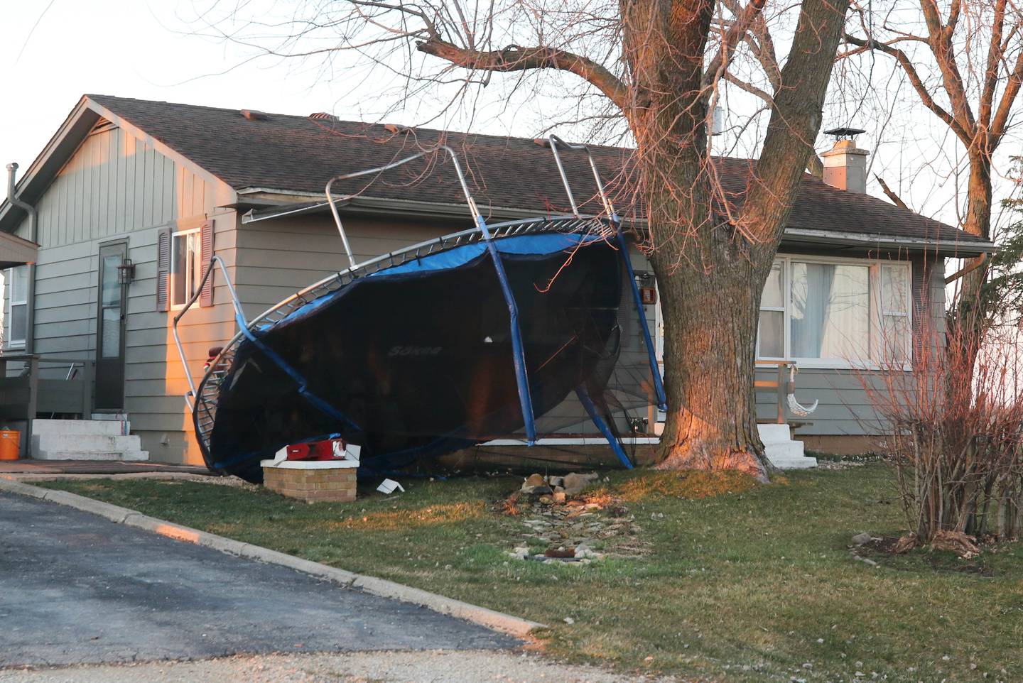 A trapoline sits upside down in front of a home near East Sandwich Road in Hinckley Wednesday, Feb. 28, 2024, after a tornado hit the area Tuesday night.