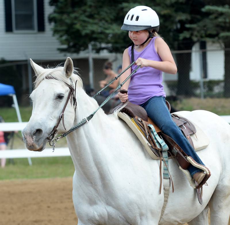 Lorelei Habben, 7, of Sterling, rides Petrie at the WHOA benefit horse show on Saturday, June 22, 2024 at the Whiteside County fairgrounds in Morrison.