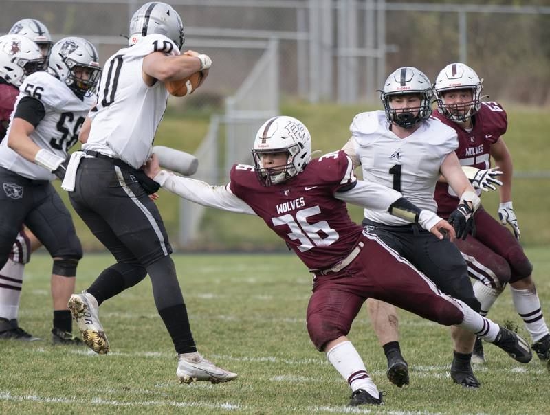 Kaneland quarterback Troyer Carlson breaks a tackle from Prairie Ridge's Giovanni Creatore during the 6A second-round football playoff game on Saturday, November 5, 2022 at Prairie Ridge High School in Crystal Lake. Prairie Ridge won 57-22.