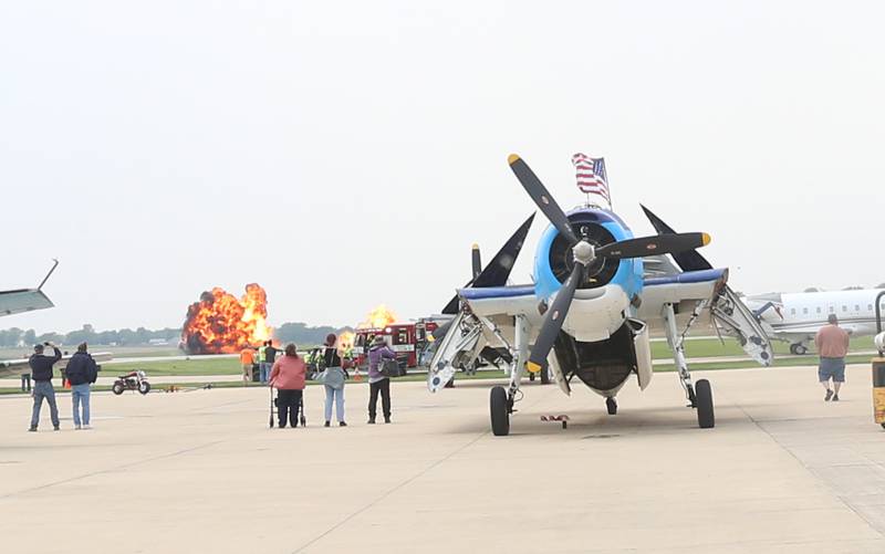 A "Wall of Fire" explosion lights the horizon behind a TBM Aircraft during the TBM Avenger Reunion on Friday, May 19, 2023 at the Illinois Valley Regional Airport in Peru.