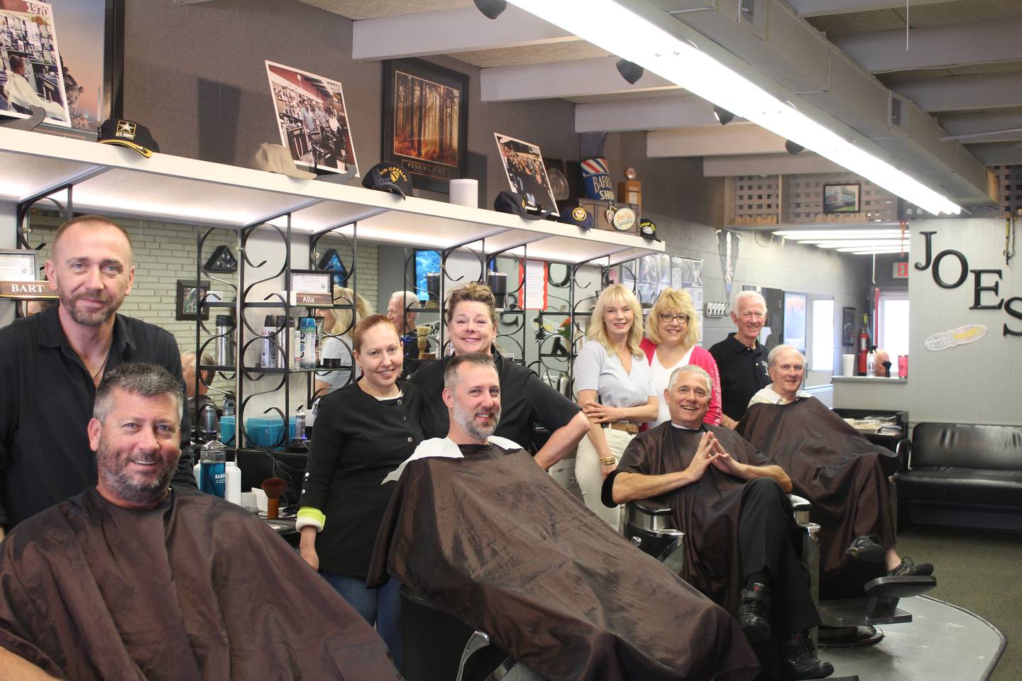 Joe's Barber Shop staff in downtown Crystal Lake celebrate Jack McArdle's 65 years of service.