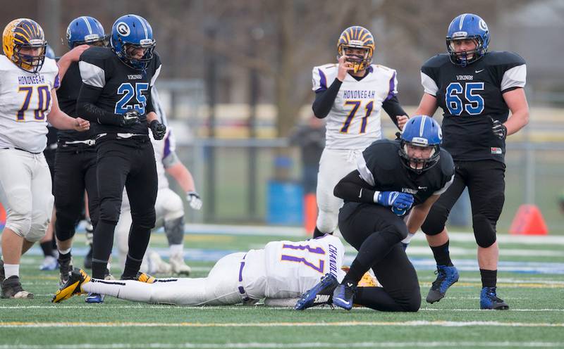 Geneva defensive end Matt Loberg sacks Hononegah quarterback Daytona Chandler on Saturday as the Vikings' Collin Lee (25) and Thomas Alwin (65) provide support during the 7A second-round playoff win for Geneva.