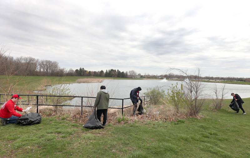 Northern Illinois University students with NIU Cares pick up garbage Friday, April 29, 2022, on campus around the West Lagoon. NIU Cares, with the help of the Trash Squirrels, was hosting a community cleanup event, going to several locations in DeKalb to pick up litter.