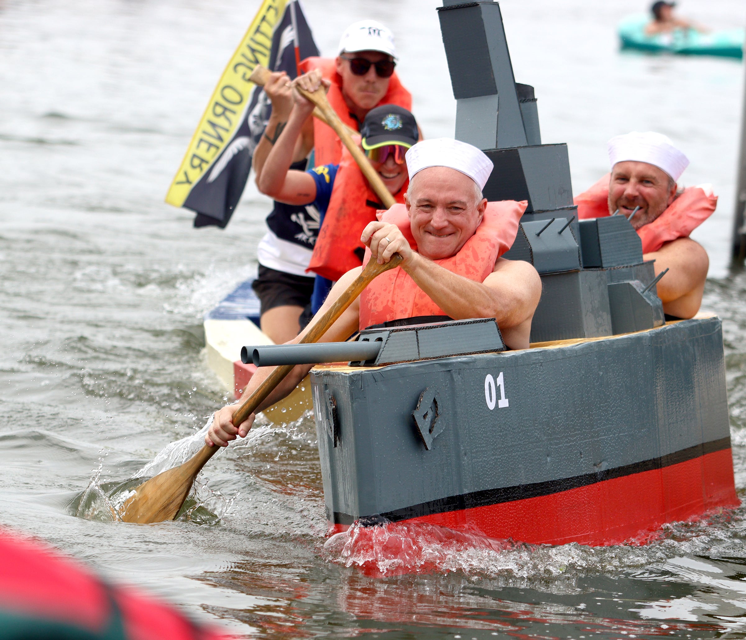 Brian Korreck, front, paddles his battleship-themed craft with teammate Sean Donahue during the Cardboard Regatta on Crystal Lake Saturday. Both are from Crystal Lake.