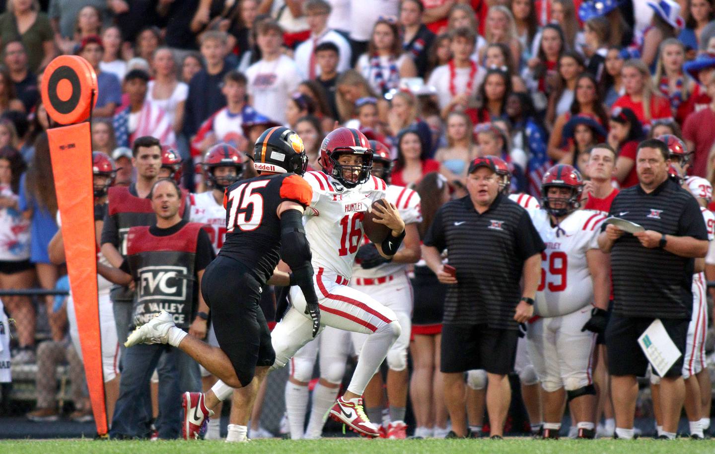 Huntley’s Braylon Bower scampers for yardage as Crystal Lake Central’s Cayden Parks, #15, pursues the play in varsity football on Friday, Aug. 30, 2024, at Metcalf Field on the campus of Crystal Lake Central High School in Crystal Lake.