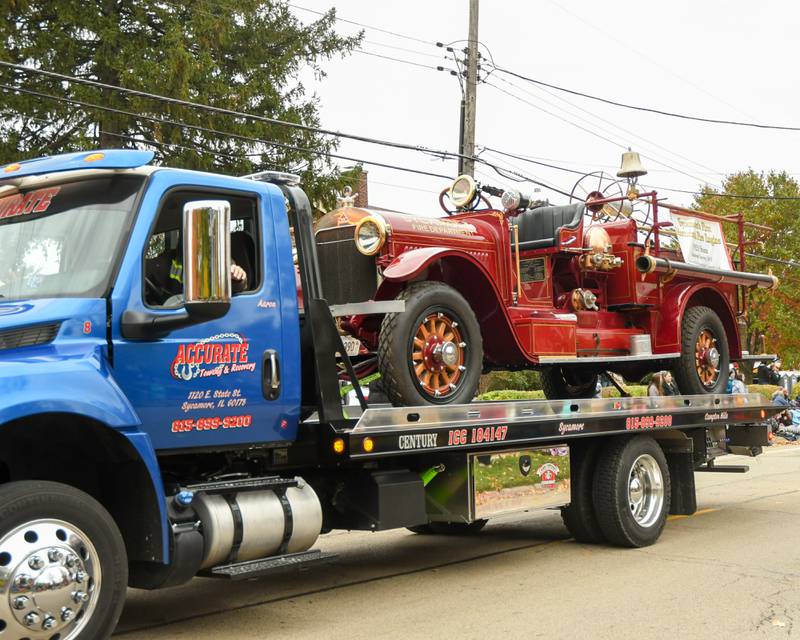 A 1923 Stutz fire engine restored in the spring of 2016 sits on a back of a tow truck driven down the parade route of the Sycamore Pumpkin Festival parade on Sunday, Oct. 29, 2023.